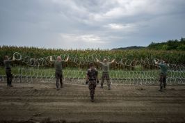 Hungary building its barb wired fence to block refugees access to pass.